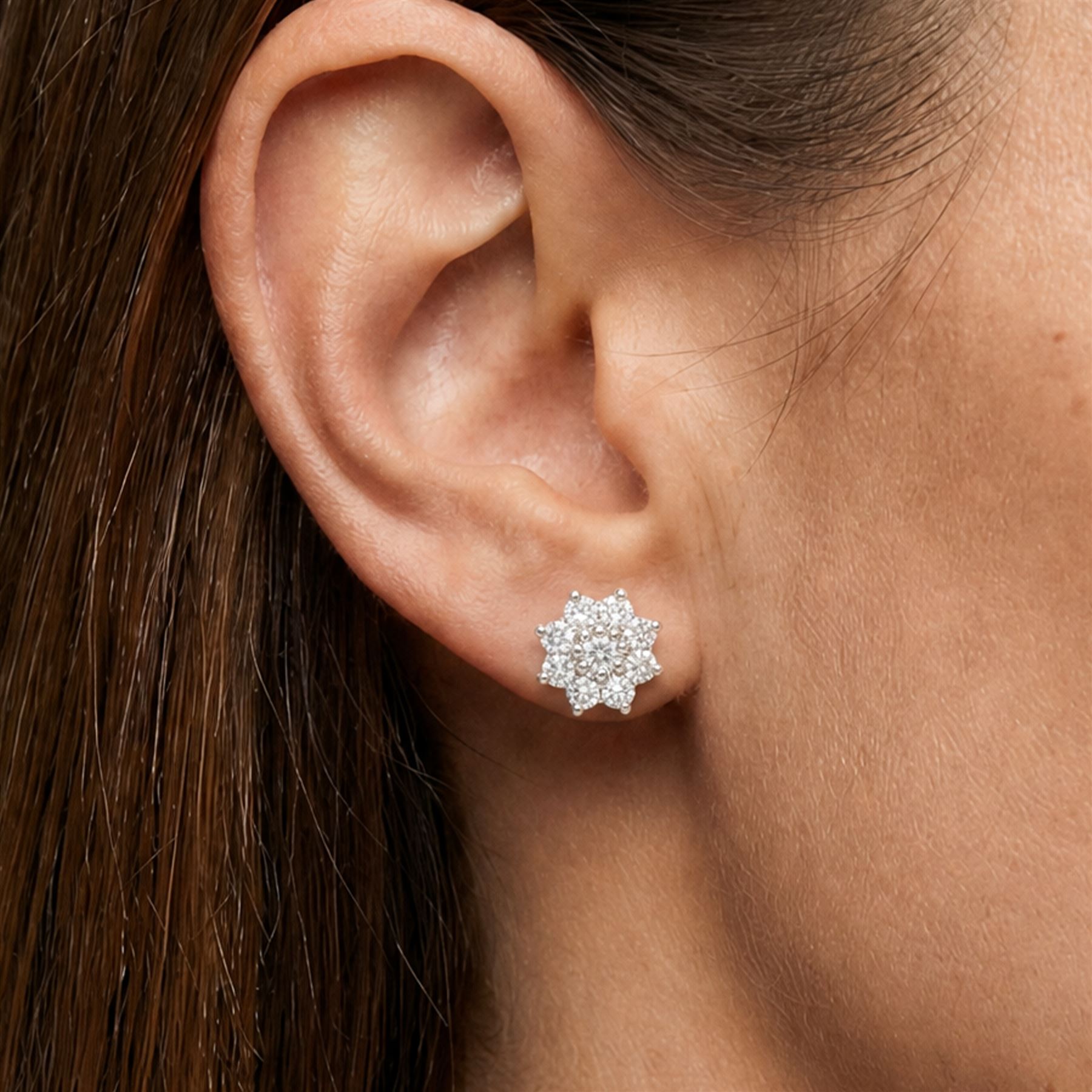 Pair of 18ct white gold diamond flower head earrings, each stud set with nine round brilliant cut diamonds, Birmingham 1996, total diamond weight approx 1.20 carat