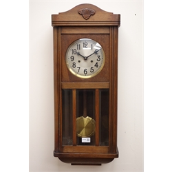  20th century oak wall clock with bevel glazed door, silvered dial and twin train movement with pull repeat, striking the half hours on a coil, H76cm  