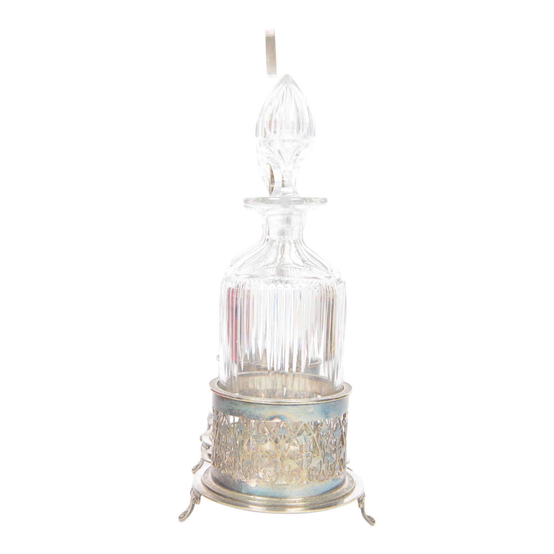Late 19th century silver plated Silber & Fleming triple decanter stand, the three cut glass decanters with spire stoppers housed within foliate and scroll pierced bottle sleeves, upon a tripart base with six scroll feet, the base mounted with articulated x-frame curved handle, including handle when positioned upright H35.5cm, W34cm