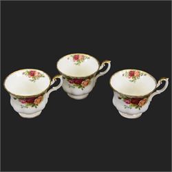 Royal Albert Country Roses tea and dinner service for six place settings, comprising teapot, milk jug, cups and saucers, dessert plates, side plates and dinner plates, all with printed mark beneath 