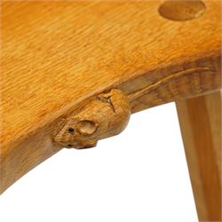 Mouseman - oak three-legged stool, dished kidney-shaped seat, raised on three octagonal splayed supports, with carved mouse signature, by the workshop of Robert Thompson of Kilburn