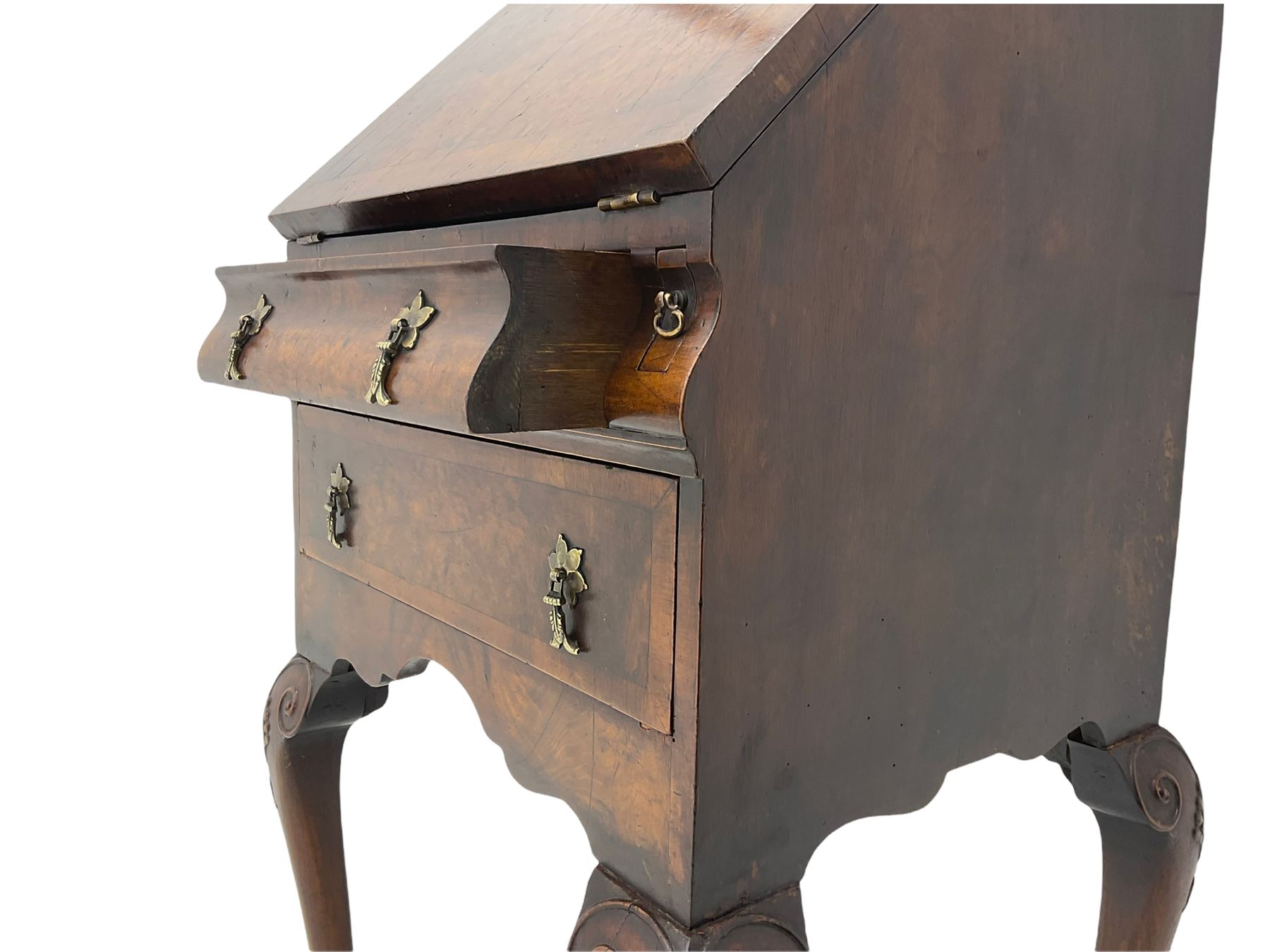 Small early 20th century Queen Anne style bookcase on bureau secretaire, the moulded arched pediment over mirrored door in shaped frame, the bureau fitted with fall front enclosing curved fitted interior, cushion moulded drawer over single drawer, on scroll and shell carved cabriole supports