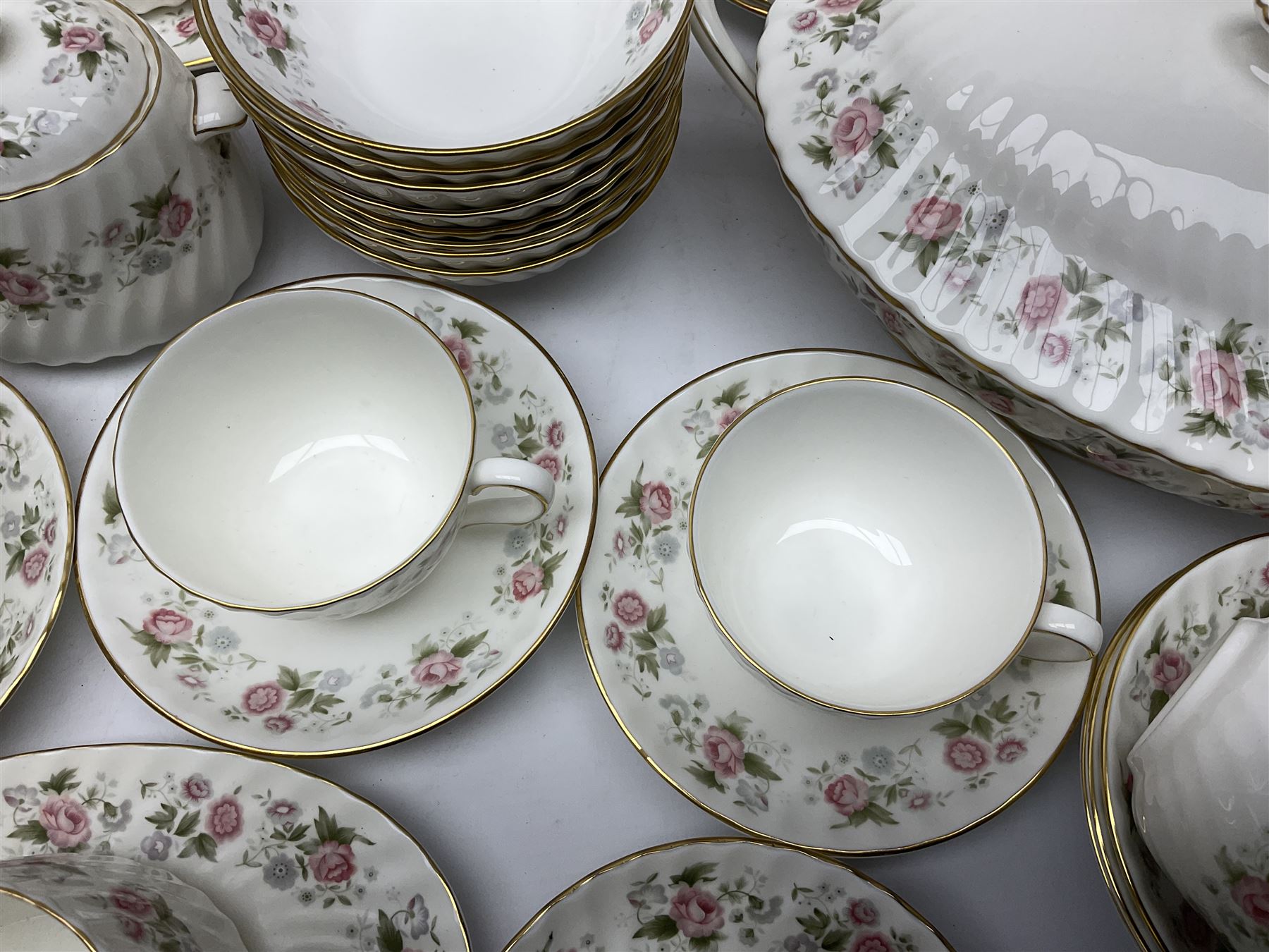 Minton Spring Bouquet pattern dinner and tea service, comprising dinner plates, twin handled tureens with covers, meat platter, teapot, milk jug, sugar bowl with cover, tea cups and saucers, bowls, cake plate, side plates, dessert plates, etc all with printed mark beneath (82)