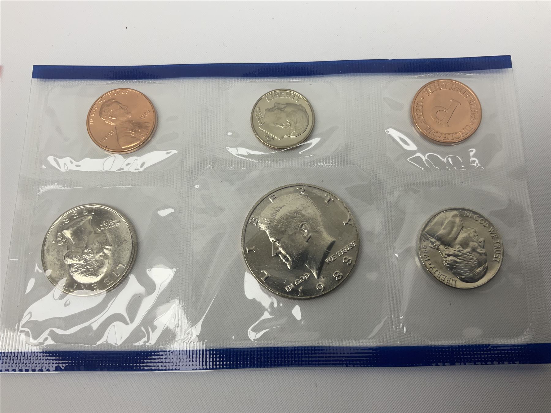 United States of America coinage, including 1876S half dollar (holed), various quarter dollars, 1986 one ounce fine silver dollar, 1988 uncirculated coin set etc