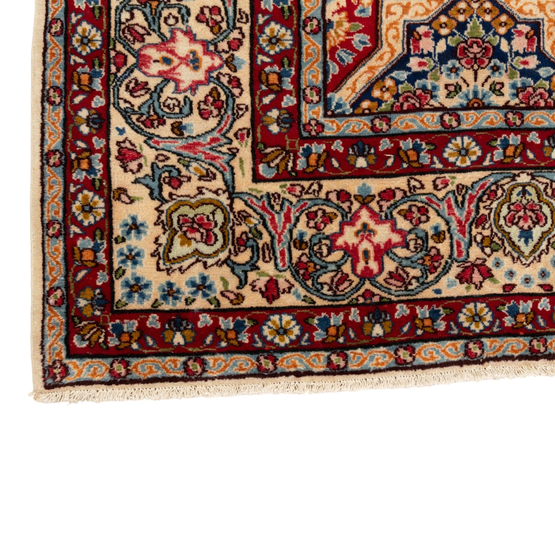Central Persian Kirman carpet, the field arranged with alternating indigo star shaped and red cruciform compartments, each filled with rosettes, flowerheads and scrolling foliage, enclosed by a broad ivory palmette border and red floral guard bands