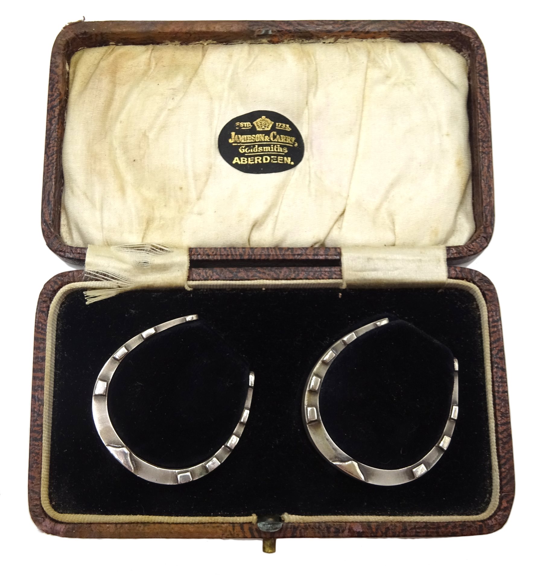 Pair of silver horseshoe napkin rings by William Base & Sons, Birmingham 1928, 
 retailed by Jamieson & Carry, Aberdeen, cased