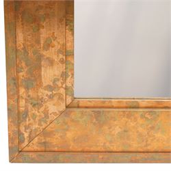Large contemporary distressed copper effect framed wall mirror, stepped frame enclosing a bevelled mirror plate