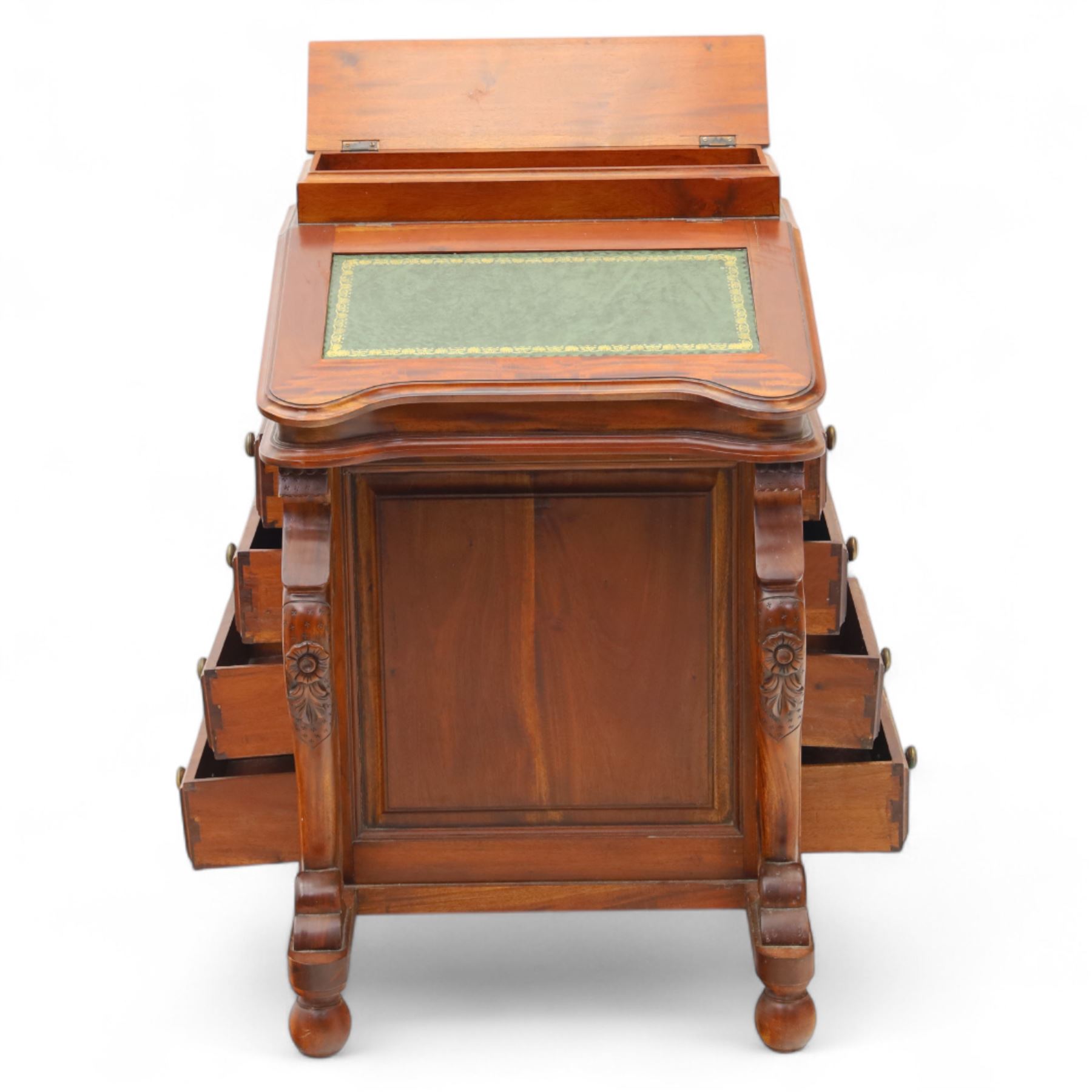 Victorian design mahogany Davenport desk, the sloped writing surface inset with tooled green leather and hinged to reveal a fitted interior, with a pen compartment to the raised gallery back, four drawers to each side, on carved scrolled supports with acanthus detail, raised on turned feet
