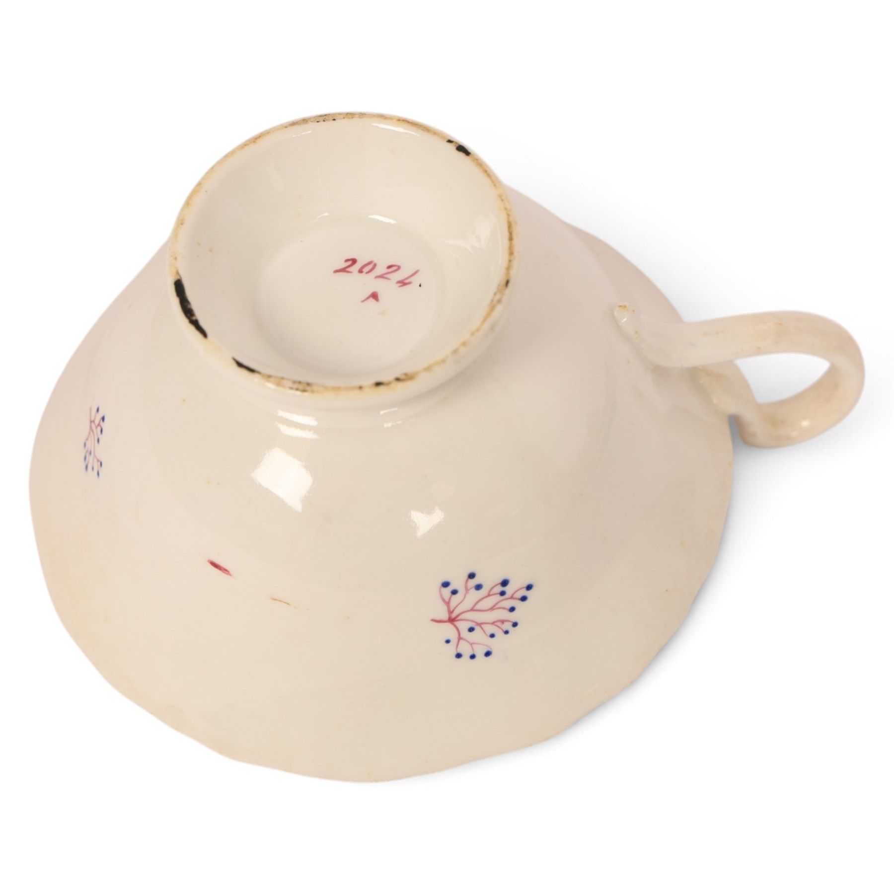 Late 19th century tea service, decorated with a green and pink strips, with internal decoration of budding branch within a gilt band upon a white glazed ground, comprising  twin handle lidded sucrier, milk jug, three serving plates, nine cups and saucers and four teacups
