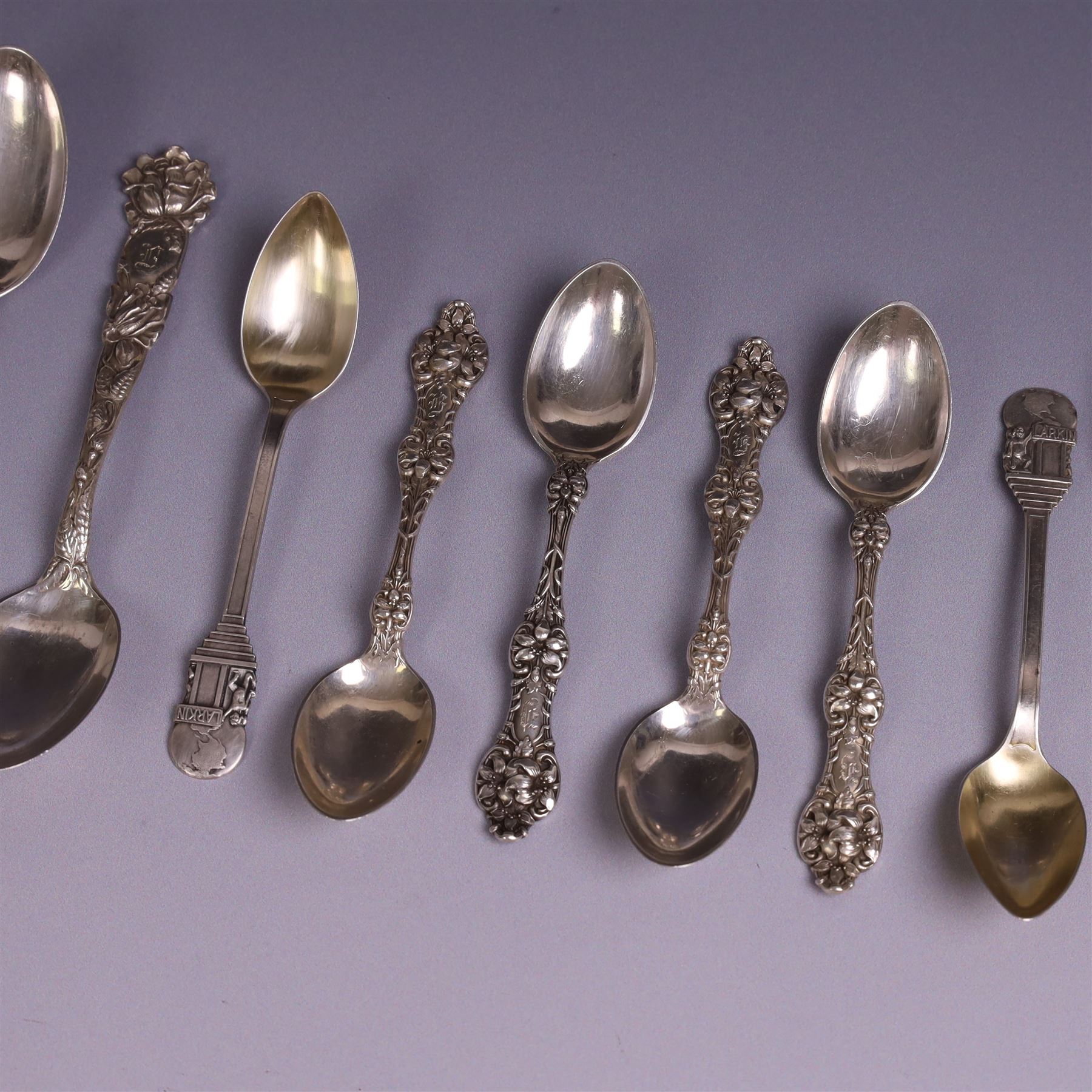 American silver tea and coffee spoons, comprising set of six coffee spoons with embossed lily decoration, set of six teaspoons with embossed rose decoration, both with engraved initials and a pair of Larkin coffee spoons, all stamped Sterling