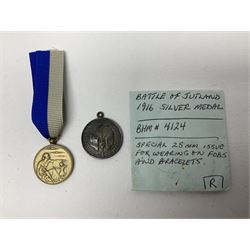 RMS Lusitania iron medallion dated 5th May, 5.5cm diameter, boxed with St Dunstan's Blinded Soldiers Profit paperwork; another unboxed similar Lusitania medallion; 30th Corps Alamein Cuxhaven medallion; Battle of Jutland 1916 silver memorial pendant; Navajo Code Talkers medallion 2000; and five other military related medallions