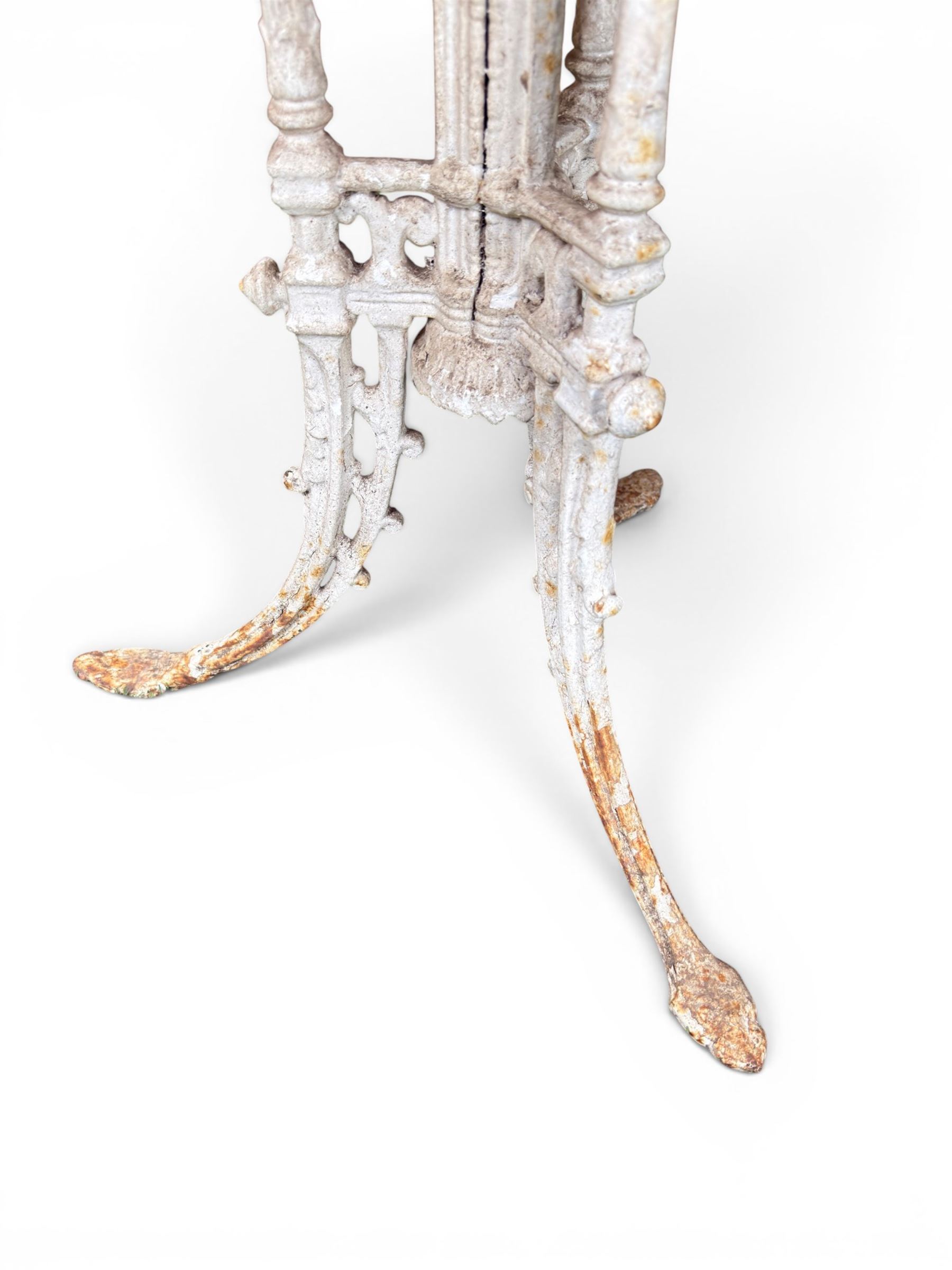 Victorian ornate cast iron garden table, trefoil base with central enclosed column, circular top with later marble, with registration mark