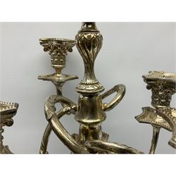Large silver plated four branch candelabra, with beaded square stepped base leading to a fluted column with Corinthian capital, supporting four scrolling branches with Corinthian sockets removable nozzles and beaded drip pans, surrounding a central conforming sconce, nozzle and drip pan, overall H64cm