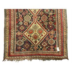 Old Persian Hamadan rug, the indigo ground field with three interlinked lozenge medallions, decorated all over with geometric and stylised motifs, eight band border with repeating geometric patterns 