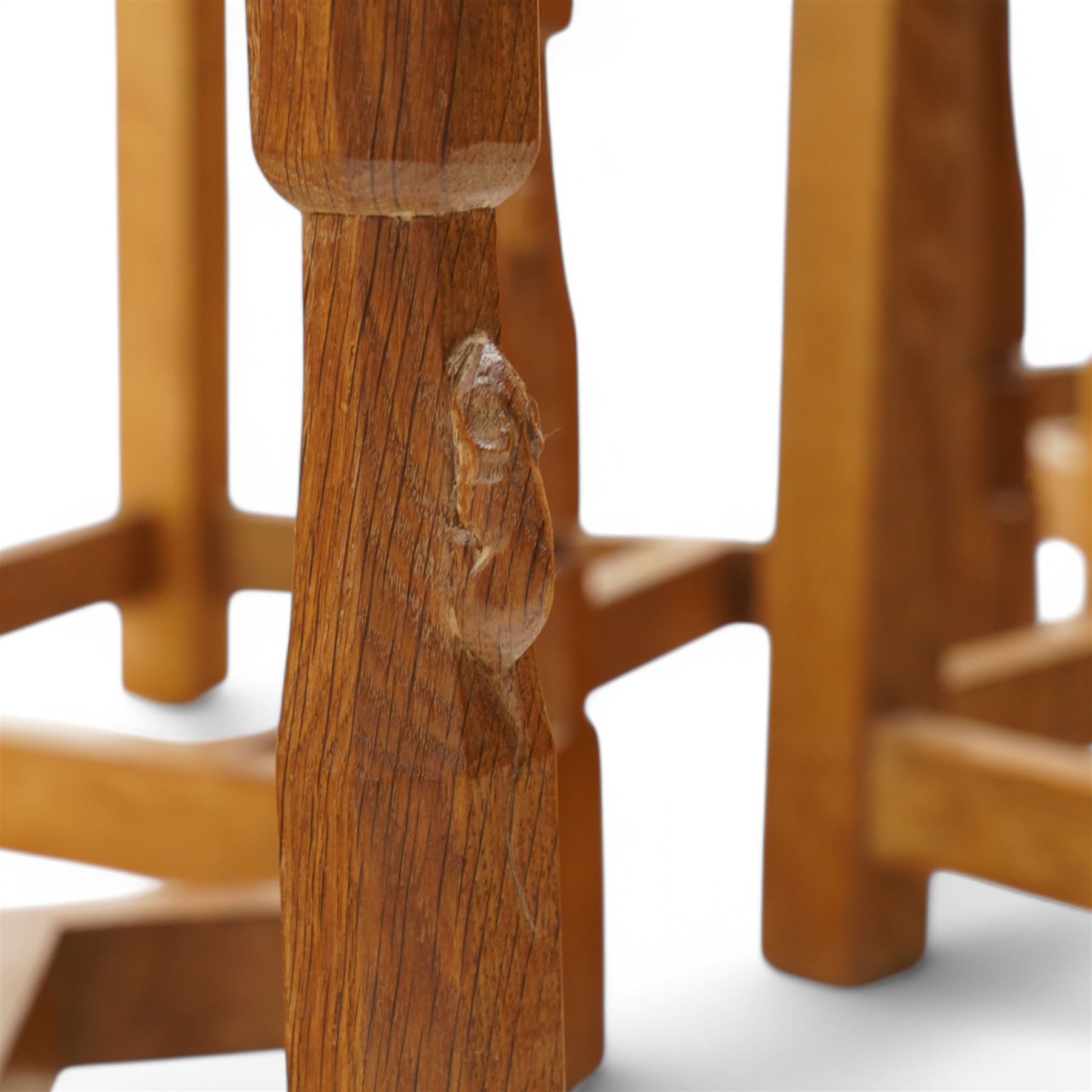 Mouseman - set of six (4+2) oak dining chairs, pierced and carved lattice back over leather upholstered seat, on octagonal front supports united by stretchers, carved with mouse signature, by the workshop of Robert Thompson, Kilburn