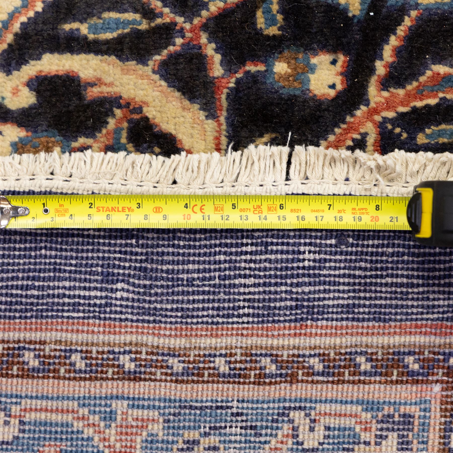 Large North West Persian Mahal hand-knotted carpet, central indigo field with a rosette medallion with an all-over design of scrolling vines and palmettes, framed by a brick red border of arabesques and flowerheads between sky blue and ivory guard stripes, with cotton fringe ends 