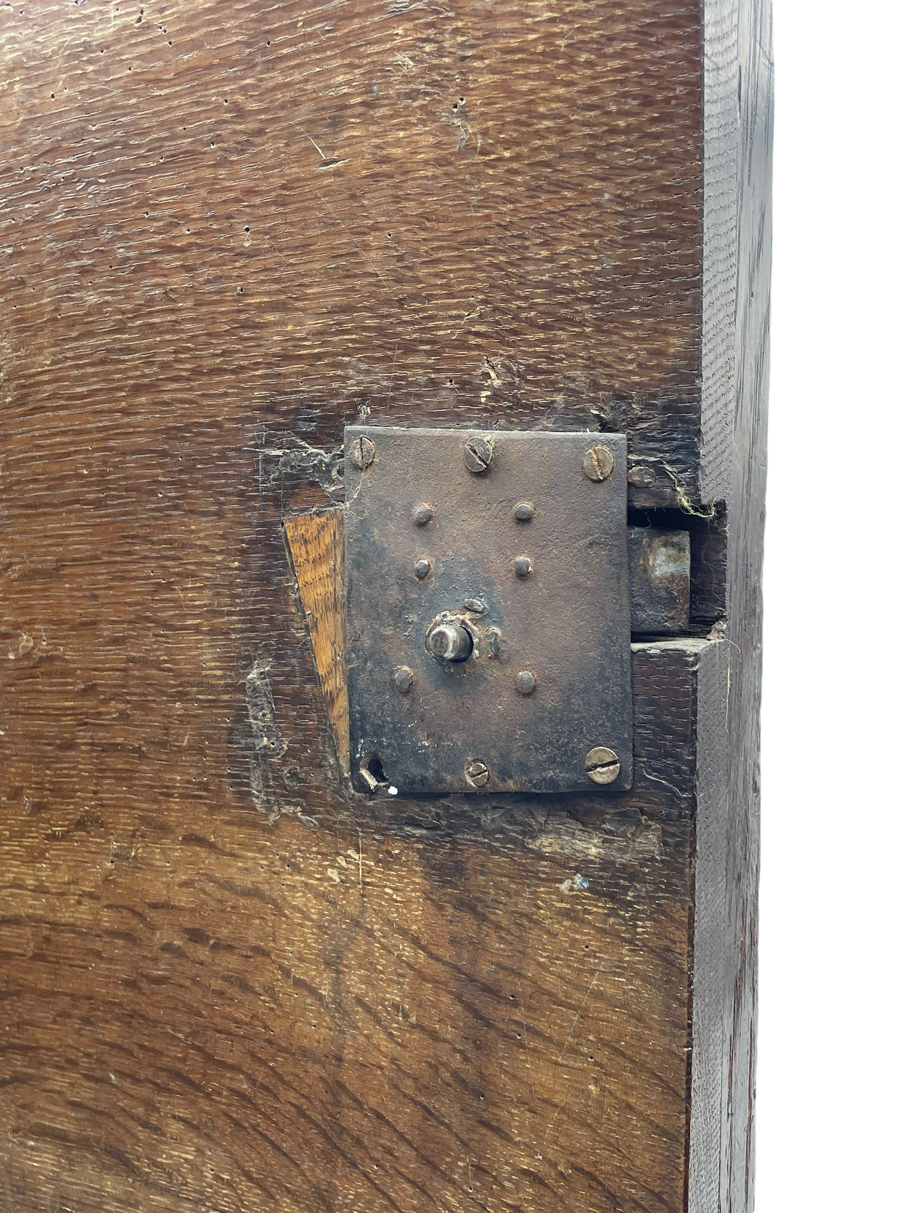 Late 17th century Flemish/Dutch rosewood and oak ‘Zeeuwse Kast’ or cupboard, projecting cornice carved with three putti masks, the uprights carved with lion masks over ribbons, flower heads and foliage, enclosed by four geometric panelled doors, lower central upright carved with flower head over foliate ribbon with bird among foliage, the escutcheon hidden by swivel berry carved cover, interior fitted with shelves, two drawers and shallow hinged cupboard, on two large turned and ebonised feet, circa 1680