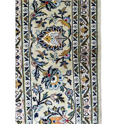 Persian pale jade ground carpet, the field decorated with all-over interlaced foliate branches and scrolling flower heads, the multi-band border with repeating palmette motifs