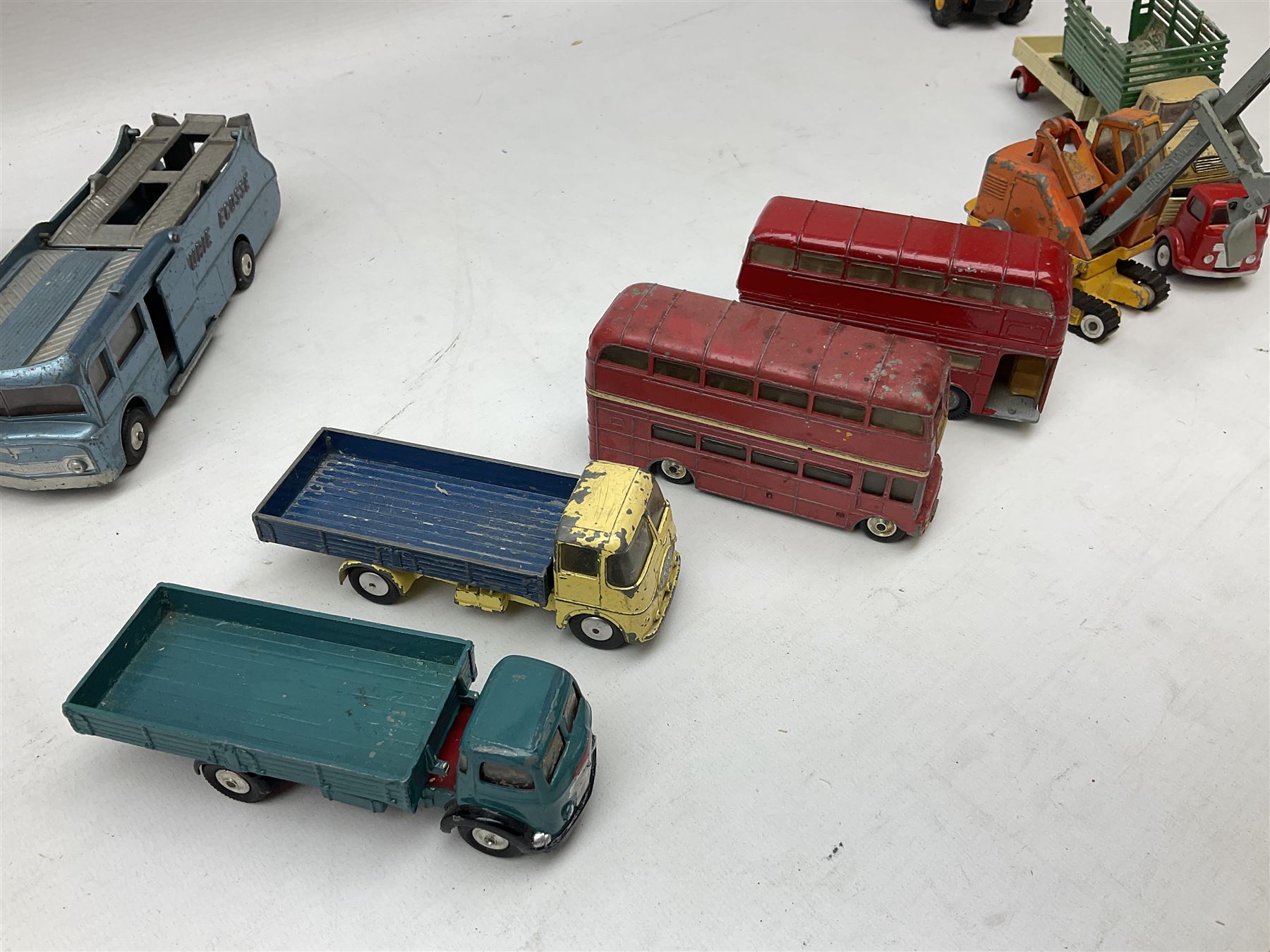 Corgi - eighteen unboxed and playworn/repainted die-cast commercial vehicles including Commer 5-Ton Wagon with drop-side trailer and two other 5-Ton wagons, Dodge Key Fargo, Jeep FC-150, two London Routemaster buses, Carrimore Trideck Transporter, two Carrimore Mark IV Transporters, Carrimore Low Loader, Ecurie Ecosse Racing Car Transporter etc (18)