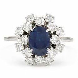 18ct white gold sapphire and diamond cluster ring, single oval cut sapphire of approx 2.10...