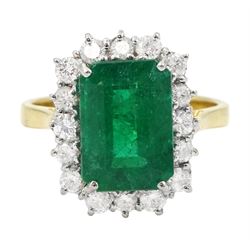 18ct gold emerald and diamond cluster ring, single octagonal cut emerald of approx 3.80 ca...
