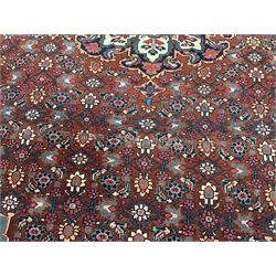 Persian Sarouk red ground rug, central medallion, reappearing field boarder 
