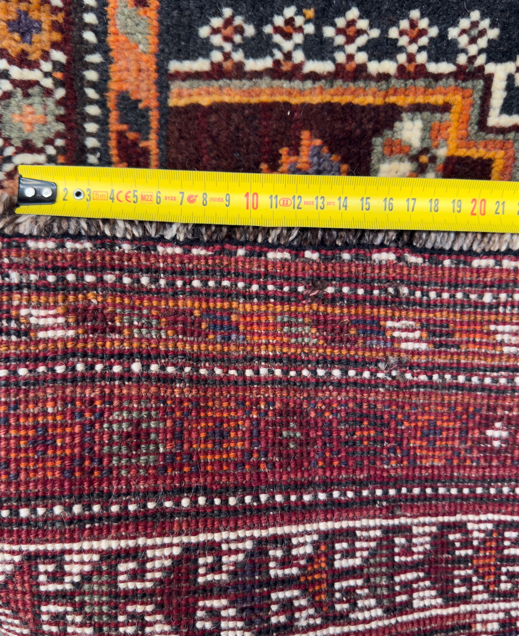 Southwestern Persian Qashqai hand-knotted carpet, the field with a lattice of hexagonal medallions in rust, indigo, and ochre, each containing stylised tree and floral motifs, flanked by lozenge panels with geometric designs, enclosed by multiple borders with rosettes and leaf motifs