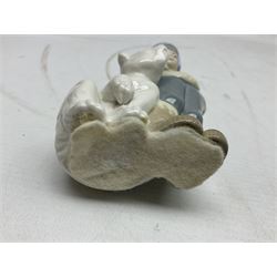 Seven Lladro figures, comprising Playful Puppy no 9135, Platero and Marcelino/Boy Hugging Donkey no 1181, Mini Seal Family no 5318, Attentive Polar Bear no 1207, Seated Polar Bear no1209, Eskimo Boy with Pet no 5238 and Girl with Geese no 1035, together with Nao goose