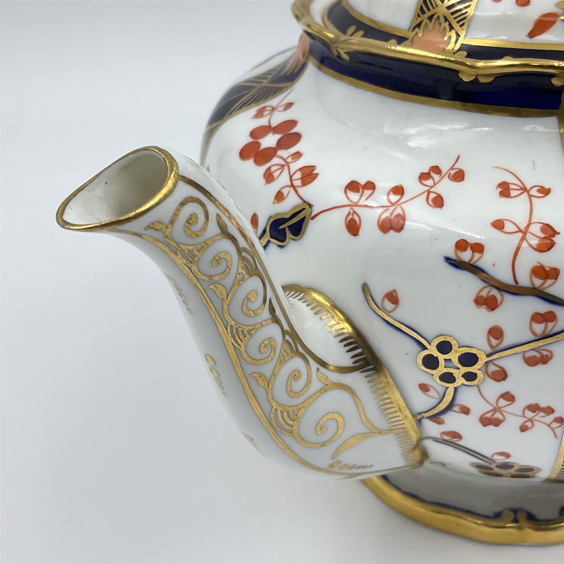 Early 20th century Royal Crown Derby teapot, decorated in a variant of the Imari pattern with blue and red prunus blossoms, with printed mark beneath including illustration date code for 1927, H14cm
