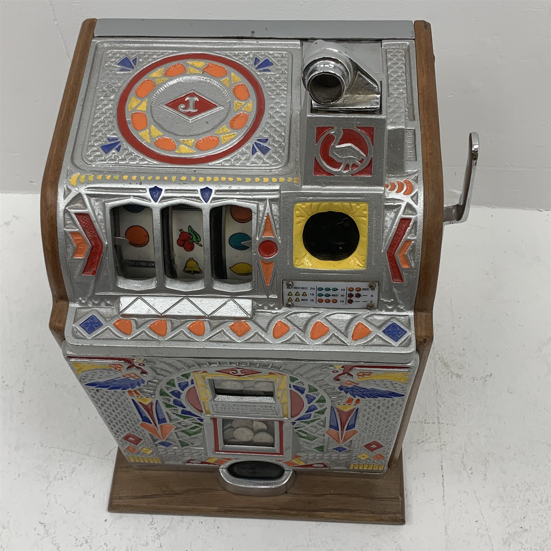 A one arm bandit fruit slot machine, the oak case with cast metal front and top with polychrome detail, with jackpot windows and single pull arm, patent no to front, H62cm. 