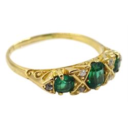 Early 20th century 18ct gold three stone emerald ring, with six diamond accents set between