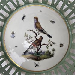 Pair of 19th century German openwork chestnut baskets, with twin handles and scrolling gilt border and star rim, painted to the centre with birds and insects, D22cm 