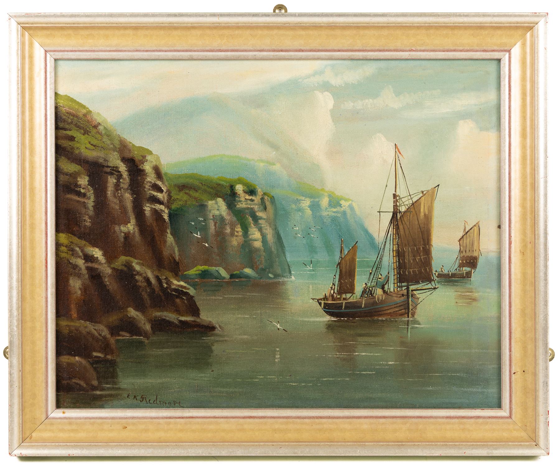 Edward King Redmore (British 1860-1941): Boats Sailing off a Rocky Coast, oil on canvas signed 37cm x 47cm