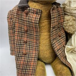 Two early 20th century straw filled jointed teddy bears, first example wearing a tweed jacket bearing Geoffrey Saville label, with leather padded paws and ears, horizontally stitched nose and humpback; second example with applied eyes, vertically stitched nose and faux leather paw pads, both with growler mechanisms, tallest H74cm 
