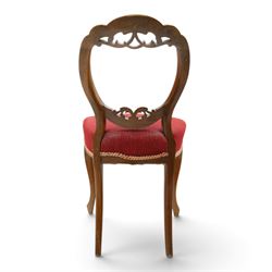 Set of five Victorian mahogany dining chairs, the scalloped balloon back with pierced scrolling acanthus leaf decoration, sprung seats upholstered in crimson fabric, on cabriole supports