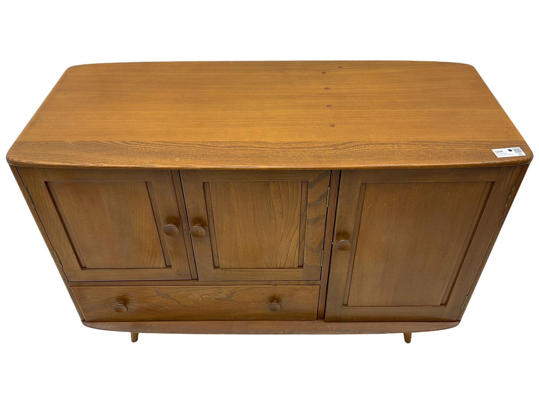 Ercol - elm and beech sideboard, fitted with cupboards and single drawer, enclosed by panelled doors, on splayed tapering feet