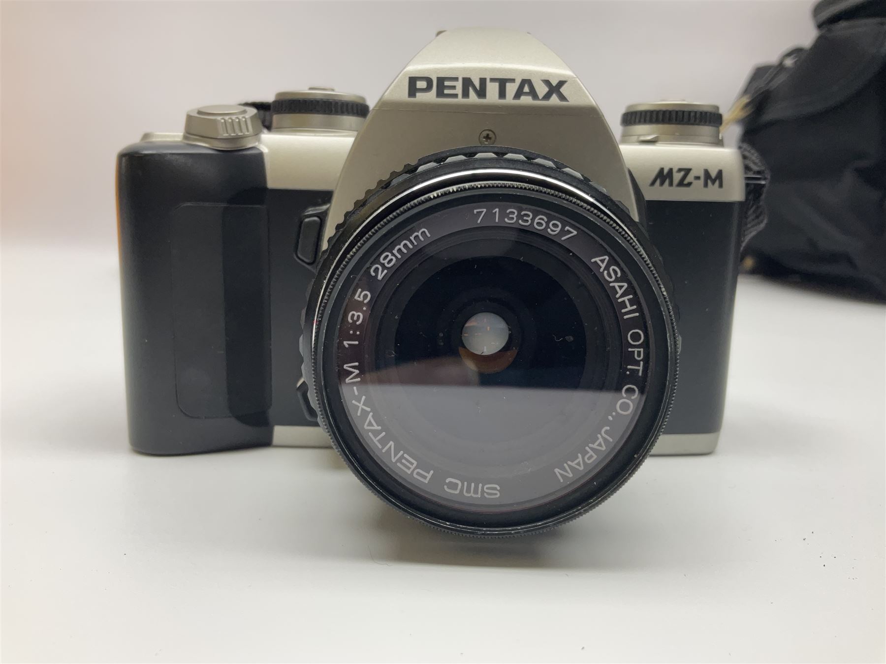 Four camera bodies, to include, Ricoh KR-10 serial no. 38826, Pentax MZ-M serial no. 4185969 with 'SMC Pentax- M 1:3.5 28mm' lens, Canon EOS500 serial no. 080927, with 'Sigma Zoom 100-300mm 1:4.5-6.7 DL'  lens etc, with other camera lenses and equipment 