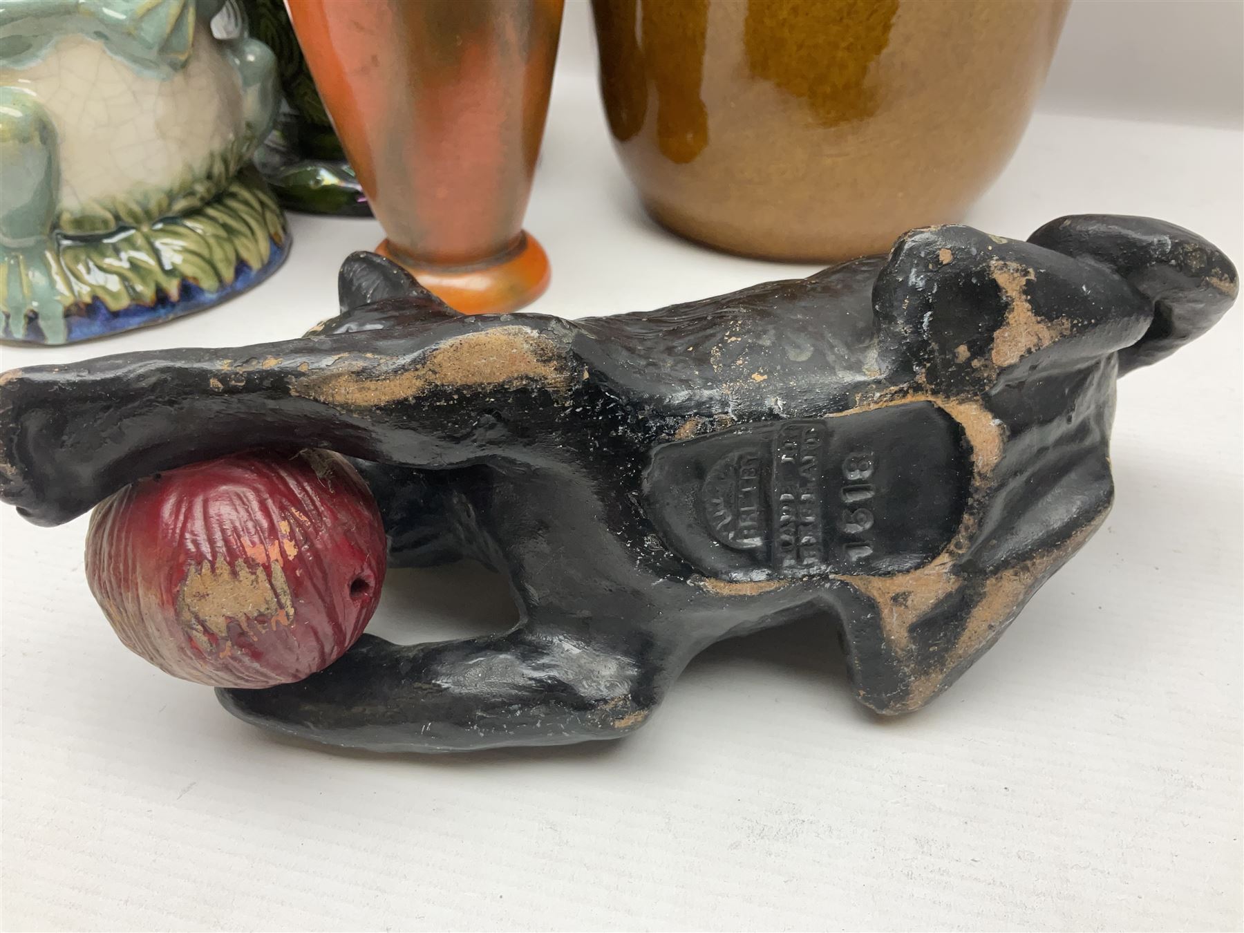 Burmantofts Faience vase, with elongated neck, and concentric circle decoration, in a green lustre glaze, together with a Bretby figure, modelled as a cat with a ball of wool, a Bretby vase, with fluted rim, in orange/red glaze, frog jug and a large West German vase, tallest H38cm