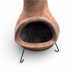 Terracotta chimney patio heater on metal stand