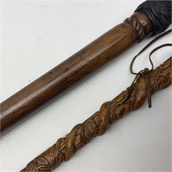 19th century wooden walking stick, the handle carved as a snake within a clenched fist, the cane carved with foliate and cross hatched decoration, with a metal spike to base, together with a turned wooden walking stick, with lacquered rope nautical knot handle, tallest L96.5cm