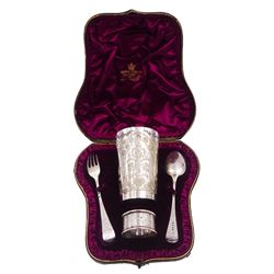 Victorian silver four piece christening set, comprising a beaker mug, napkin ring, fork and spoon, with bright cut floral decoration and monogrammed initials to each item, mug hallmarked Mappin & Webb (John Newton Mappin), Sheffield 1884, within tooled leather fitted case