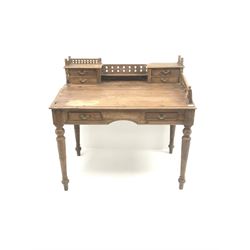 Eastern hardwood clerks desk, raised back with pierced gallery, four small drawers above sloping front, two long drawers, turned supports