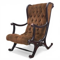 Late 20th century Regency style mahogany framed reading chair, the shaped and moulded frame with scrolled arms and open sides, upholstered in buttoned brown velvet, raised on curved supports terminating in scroll feet