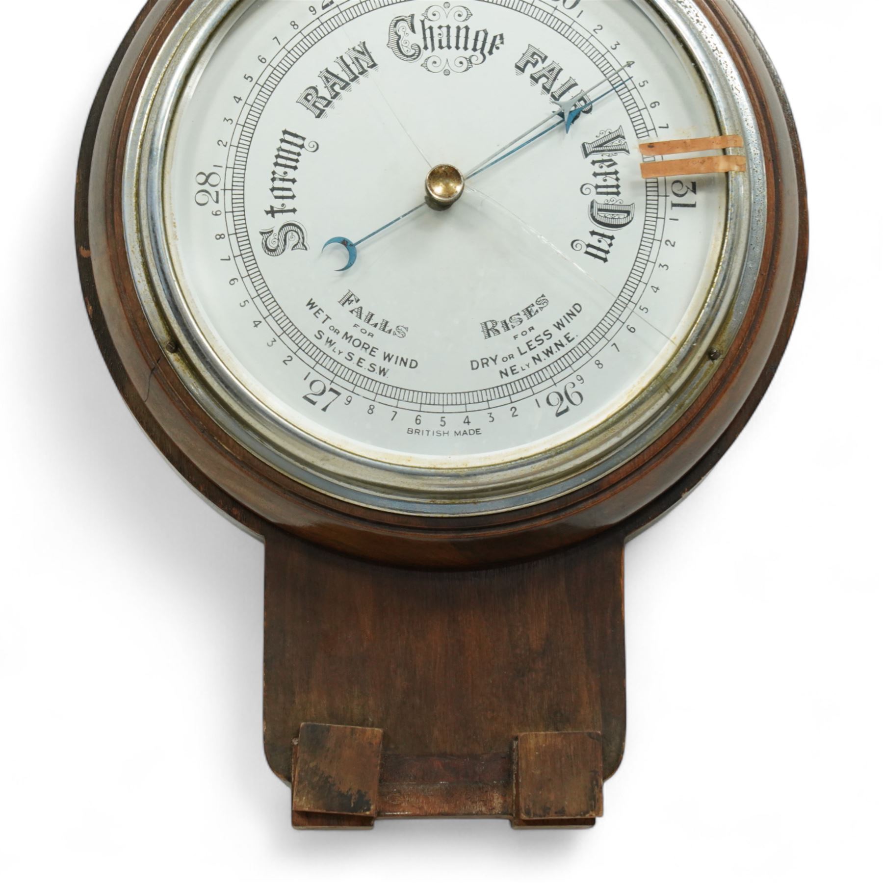 An English 20th century aneroid barometer with a slivered dial and surface mounted mercury thermometer.