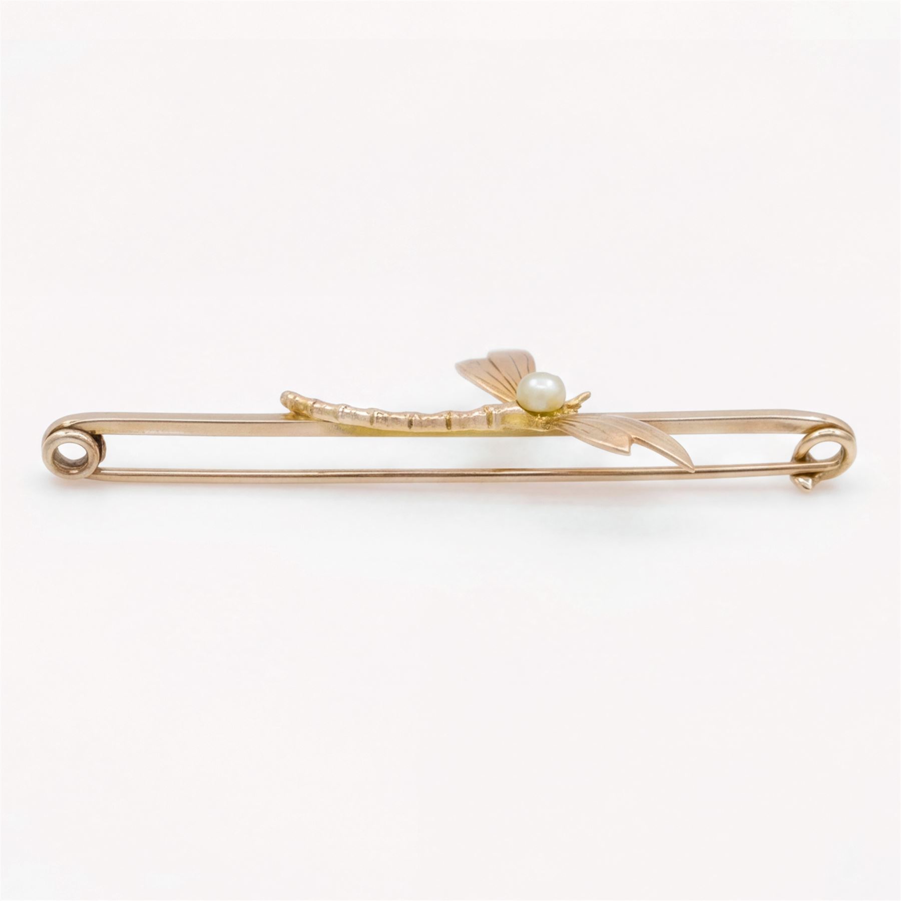 Early 20th century rose gold dragonfly bar brooch, set with a single white / cream pearl, stamped 9ct