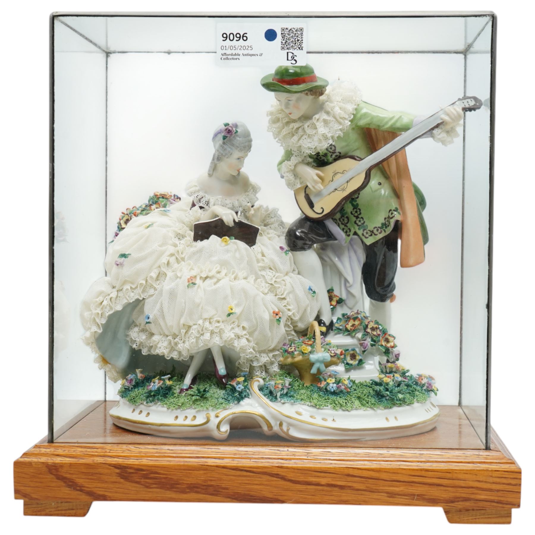 Unterweissbach style porcelain figural group of a seated lady with a gentleman playing a lute, stamped 'Foreign' to base, in bespoke display case