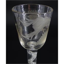 18th century drinking glass, the rounded funnel bowl engraved with thistle and floral sprig, upon a single series air twist stem and domed foot, H16cm
