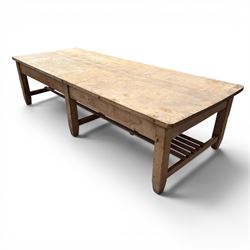 Large early/mid-20th century pine table or work bench, rectangular six plank top on eight tapering supports joined by slatted undertier