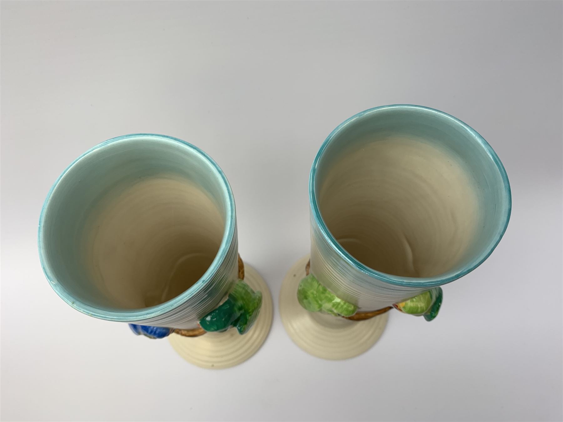 A pair of Clarice Cliff Newport Pottery vases, of tall ribbed conical