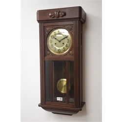  Early 20th century carved oak cased wall clock, circular Arabic dial, twin train movement striking the hours and half on coil, H74cm  